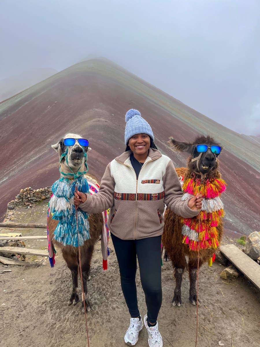 Located near her favourite city in Peru, Smith poses proudly with two alpacas decked in sunglasses at Vinicunca, more popularly known as Rainbow Mountain. 