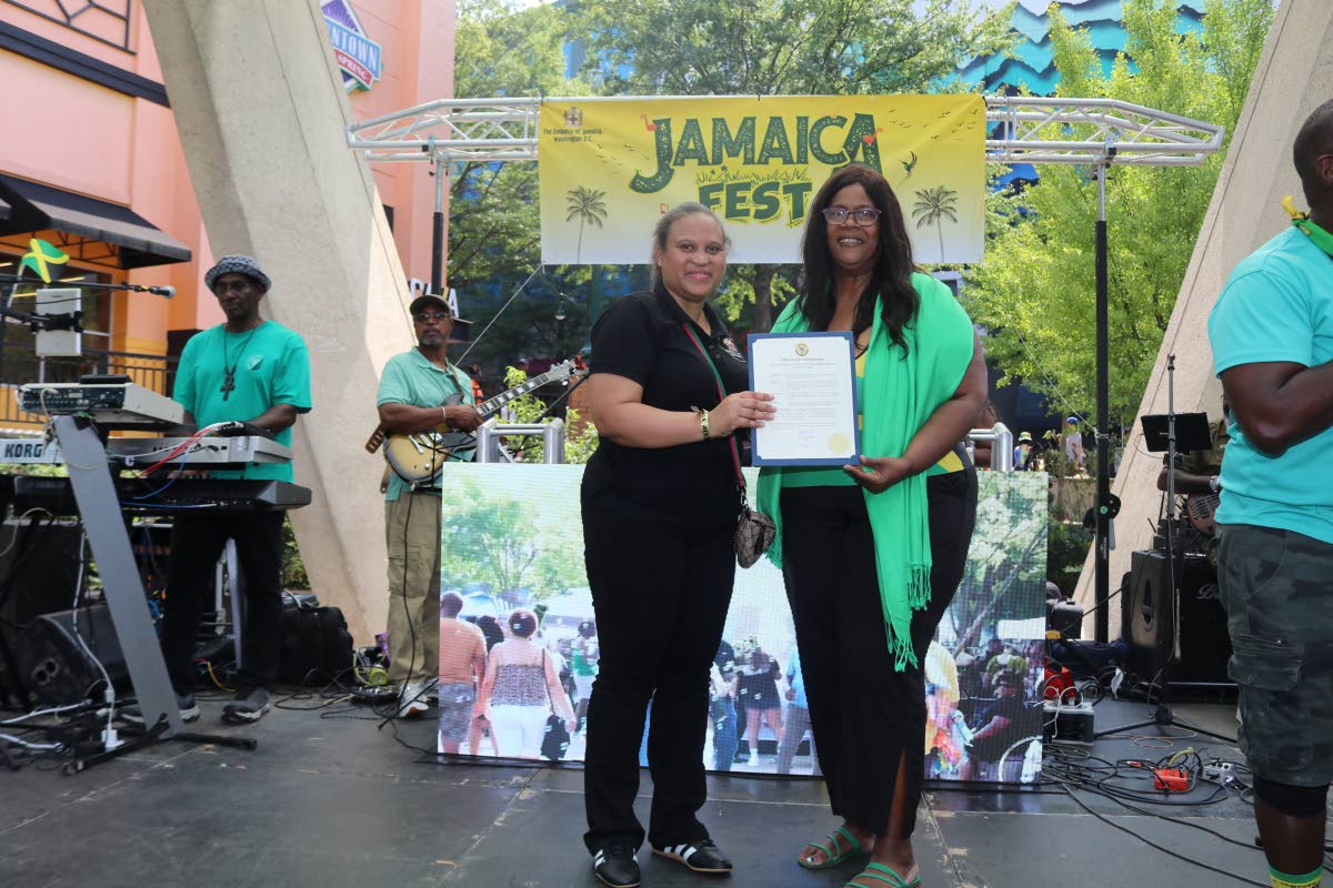 Chargé d’Affaires, a.i., at the Embassy of Jamaica in Washington, DC, Lishann Salmon (left), receives a Mayoral Proclamation from Mayor Phylecia E. Nembhard of New Carrollton, Maryland, during Jamaica Fest at Veterans Plaza in Silver Spring, Maryland, o