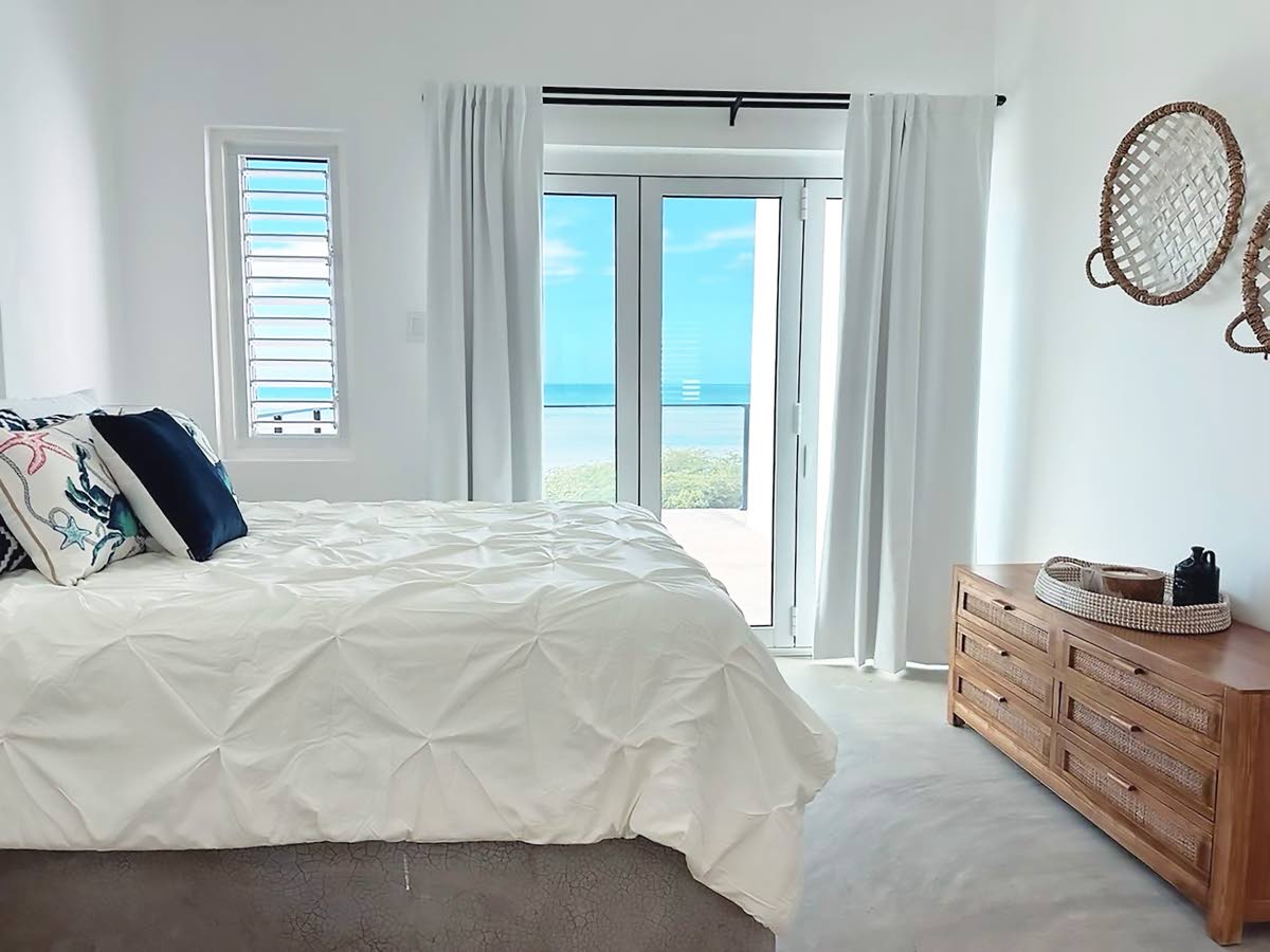 Balconied bedrooms invite sea breeze and views inside.