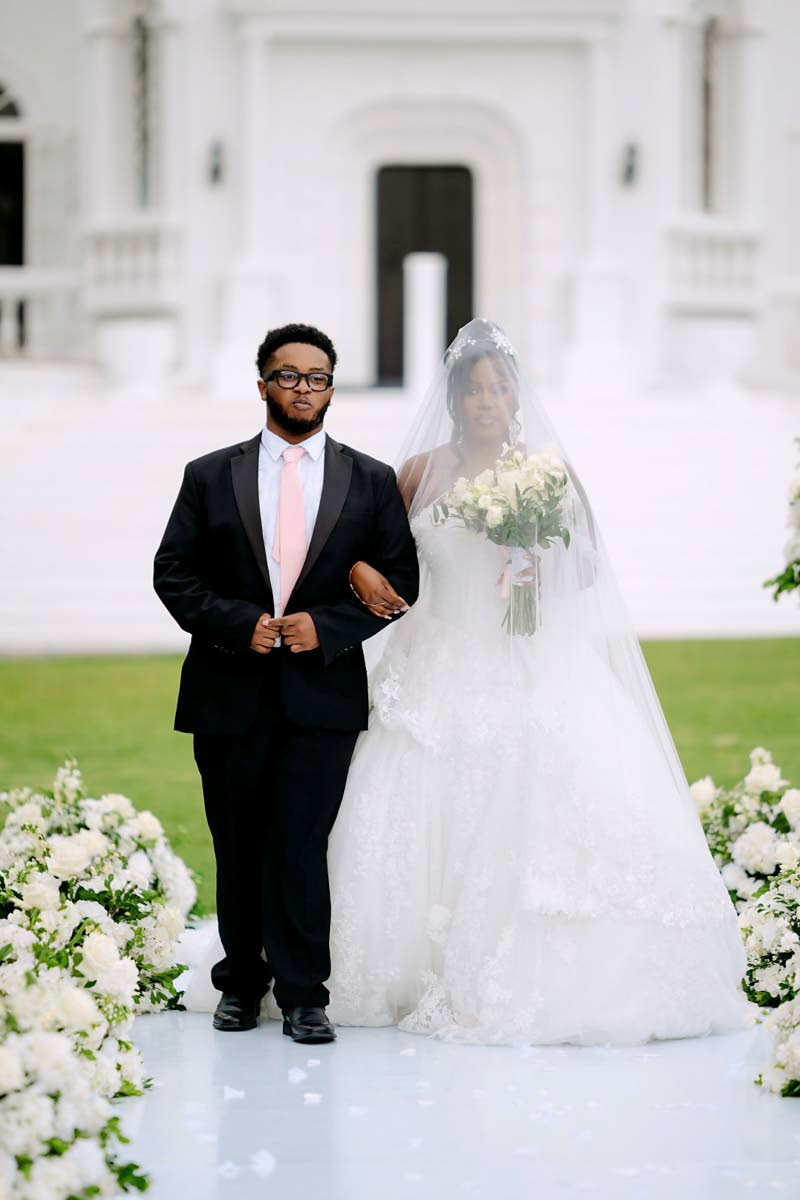 The beautiful bride is escorted down the aisle by her son, Obryan Millwood.