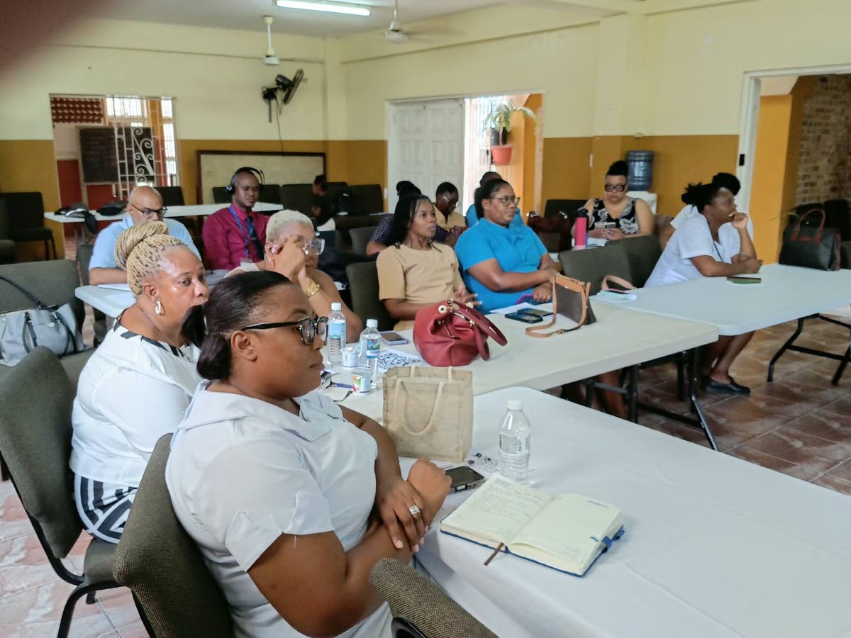 Medical practitioners and public health nurses of the Western Regional Health Authority listen attentively during one of the sessions.