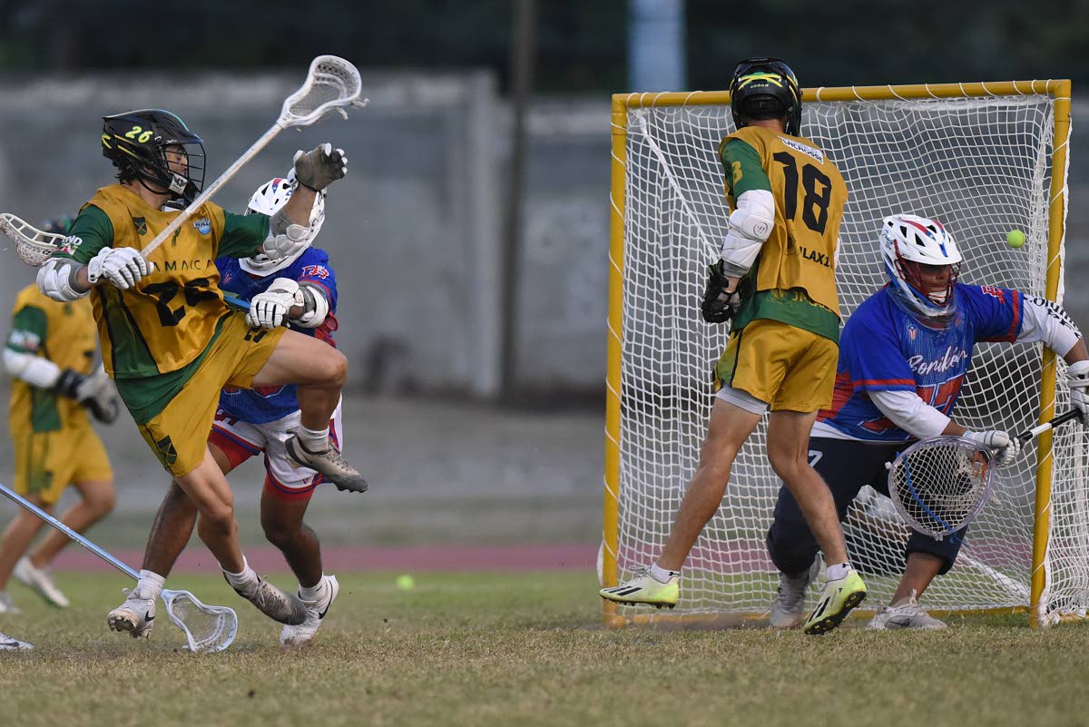 Ian Allen/PHotographer 
Hayden Hiltz (left) from Jamaica scores against Puerto Rico duing the 2026 Pan-American Men’s Lacrosse Championship at the Stadium East field on Friday. 
