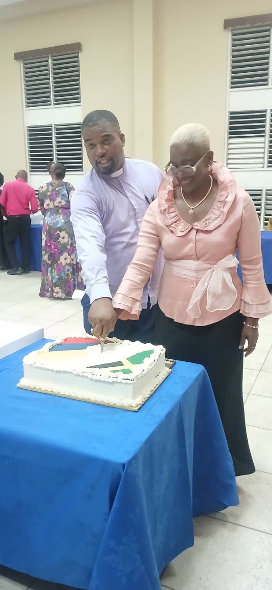
Reverend Devere Nugent, pastor of the East Queen Street Baptist Church in downtown Kingston and Colombian Ambassador to Jamaica Emiliana Bernard Stephenson prepare to cut the ‘unity cake’ between Jamaica and Colombia.