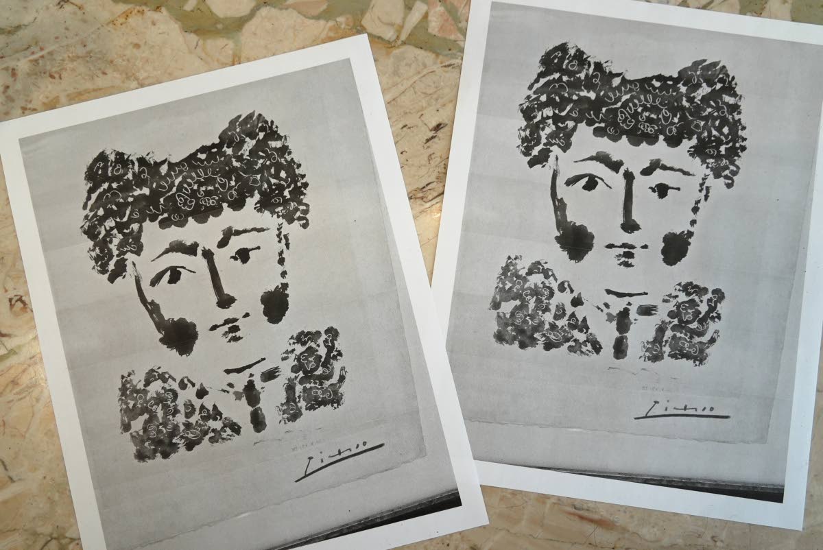 Printouts of a photo of the Pablo Picasso etching ‘Torero’ are displayed on a table in DeLind Fine Art Appraisals in Milwaukee on August 14, 2026.