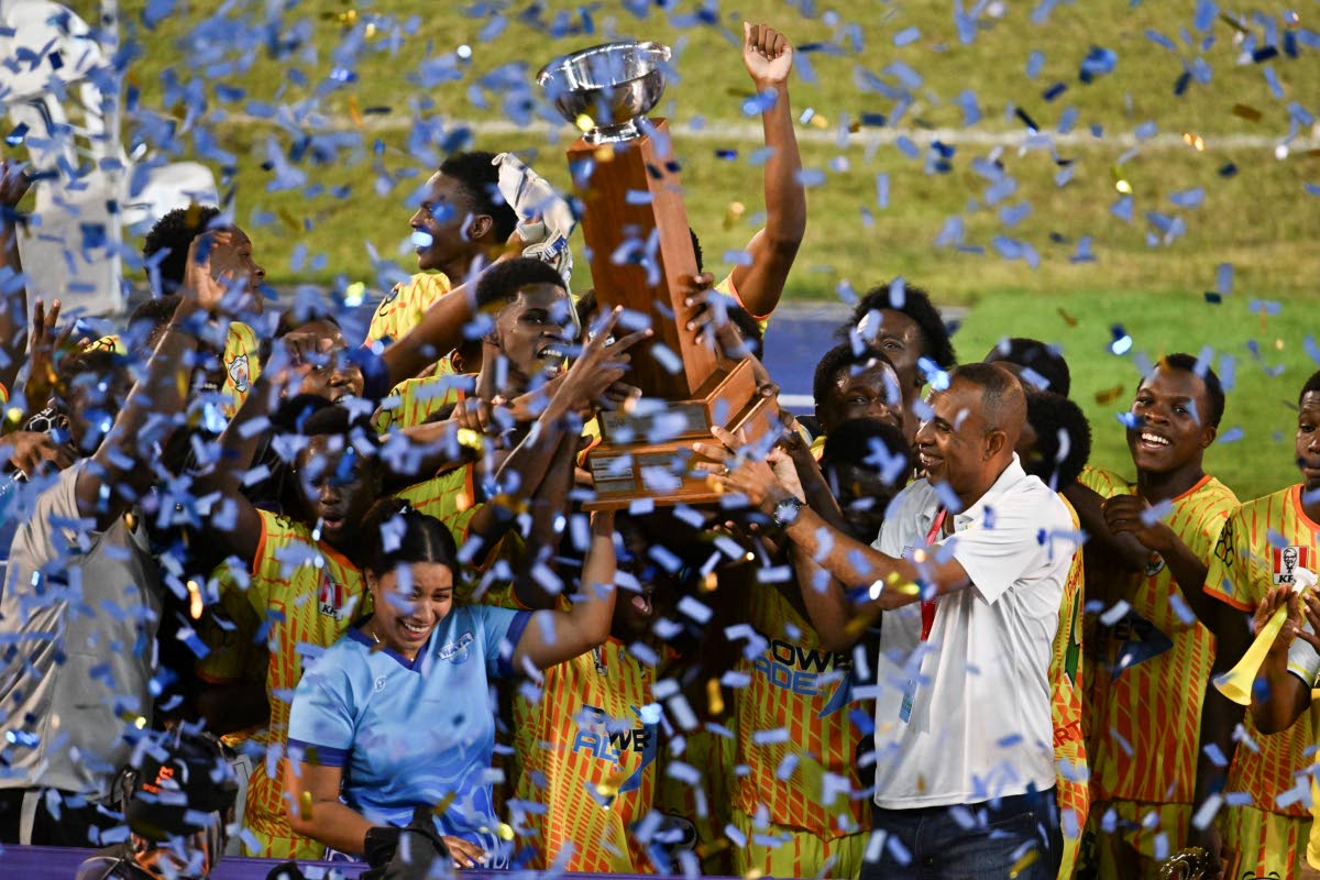 Garvey Maceo High School’s players celebrate winning the ISSA WATA daCosta Cup after defeating McGrath High School 5-3 on penalties in the final at the National Stadium last season. The game ended 1-1 in regulation time.