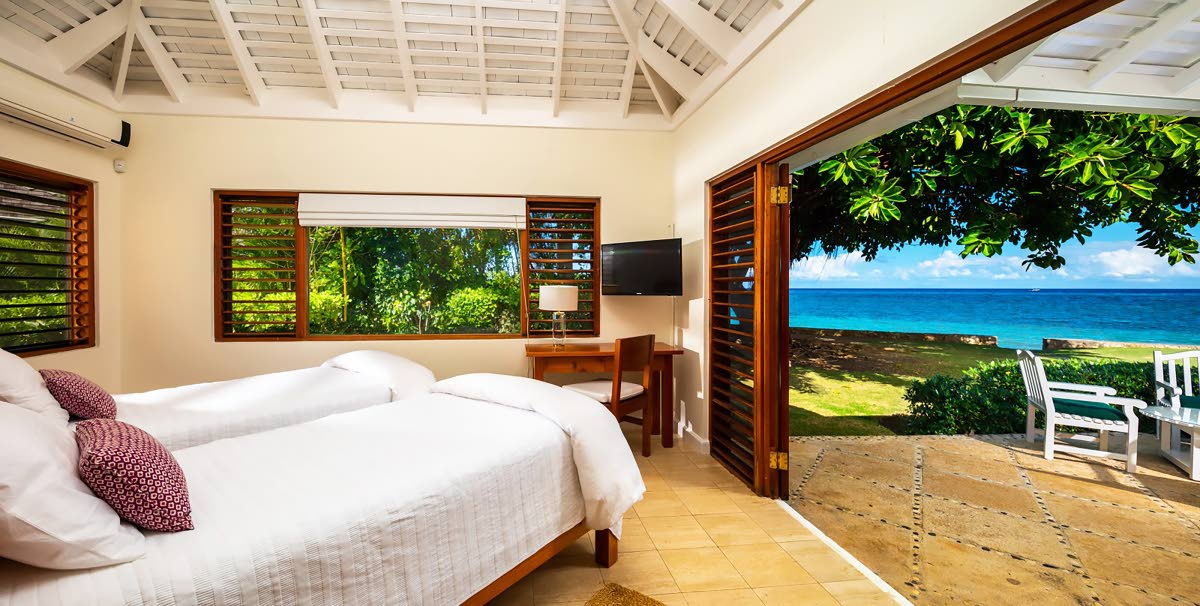 This bedroom is at one with the outdoors. 