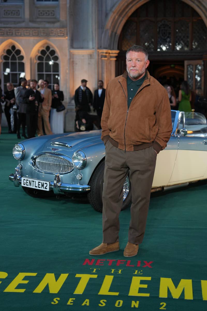 Director and executive producer Guy Ritchie keeps it casual in earthy tones.