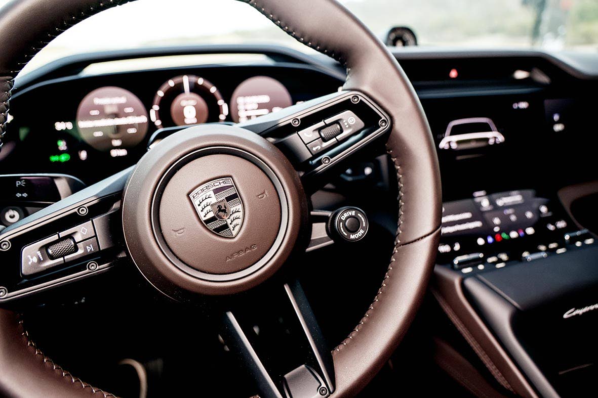 A leather-wrapped steering wheel puts multi-function controls directly at your fingertips ahead of the curved digital instrument display.