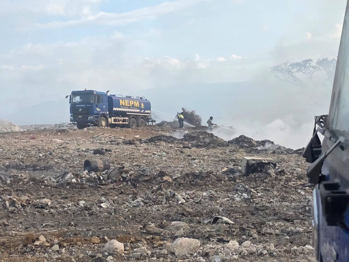 Work crews responding to a fire at the Haddon disposal facility in Moneague, St Ann