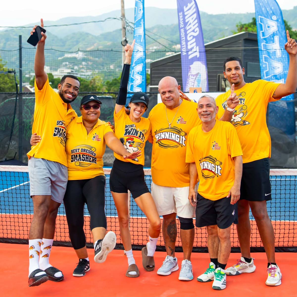 All smiles from The Best Dressed Chicken team, which brought plenty of energy to the courts. Celebrating are  R’yan Bent (left) and Ingrid Banton (second left) of the Best Dressed Smashers; Rebecca Levy (third left) and Austin Levy (right) of Wing it & W