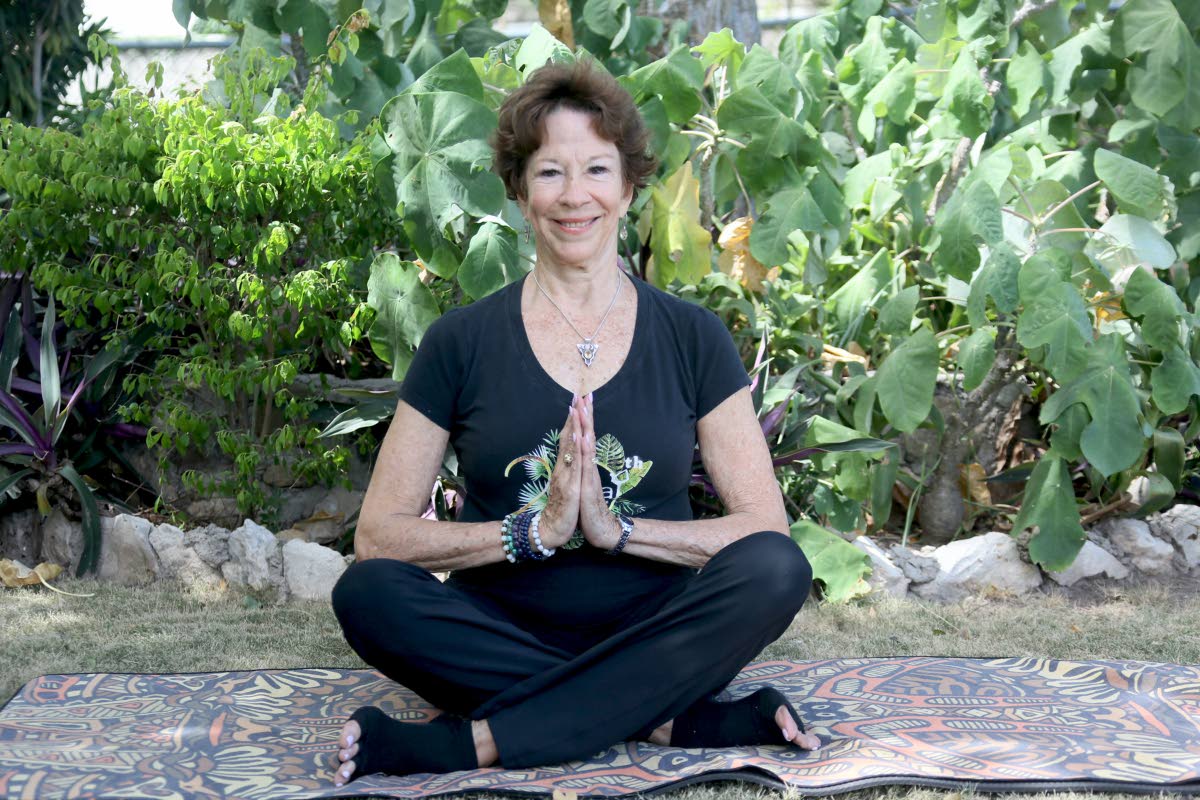 Sonita Abrahams Burrowes closes her hands in a namaste pose, reflecting the sense of balance and centredness that five decades of practising yoga have brought to her life.