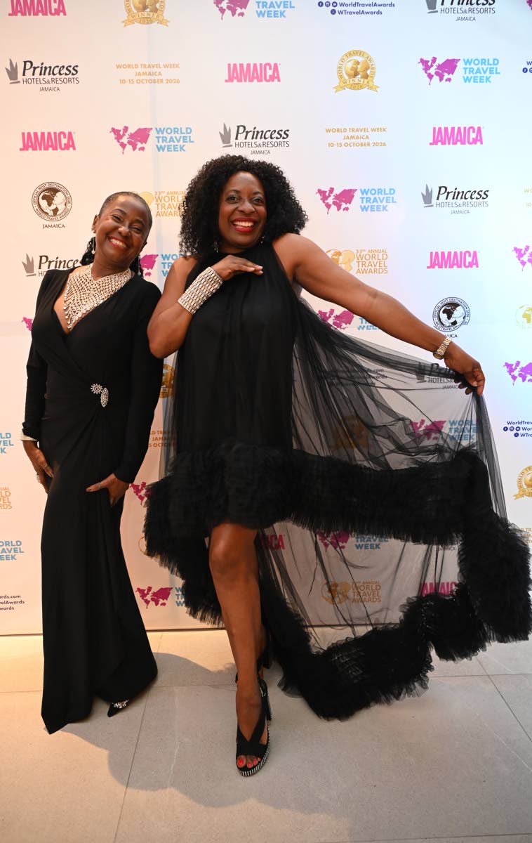 Striking playful poses for the lens while donning fabulous outfits are Marsha-Ann Donaldson (left), corporate director of weddings and romance at Sandals Resorts International, and Janet Silvera, journalist at The Gleaner Company (Media) Limited.