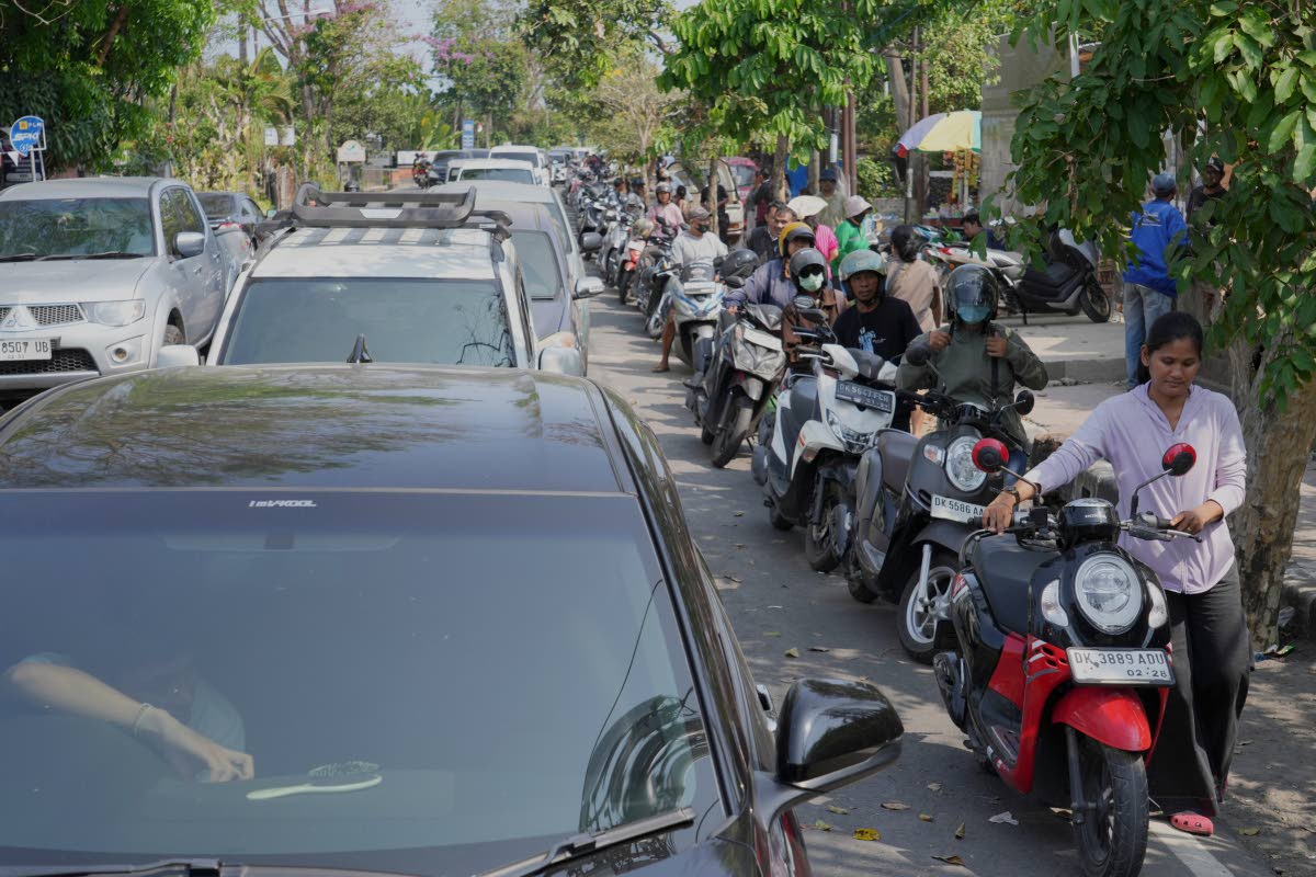 People queue at a gas station amid a fuel shortage in Denpasar, Bali, Indonesia, Wednesday, Oct. 14, 2026. (AP Photo/Firdia Lisnawati)