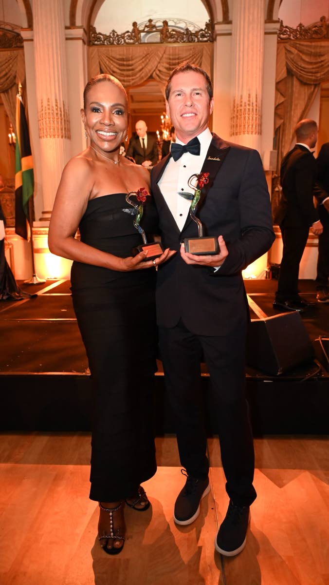 Jamaican-American actress Sheryl Lee Ralph (left), recipient of the International Humanitarian Award, and Adam Stewart, executive chairman of Sandals Resorts International, recipient of the International Achievement Award, pose for the camera at the Americ