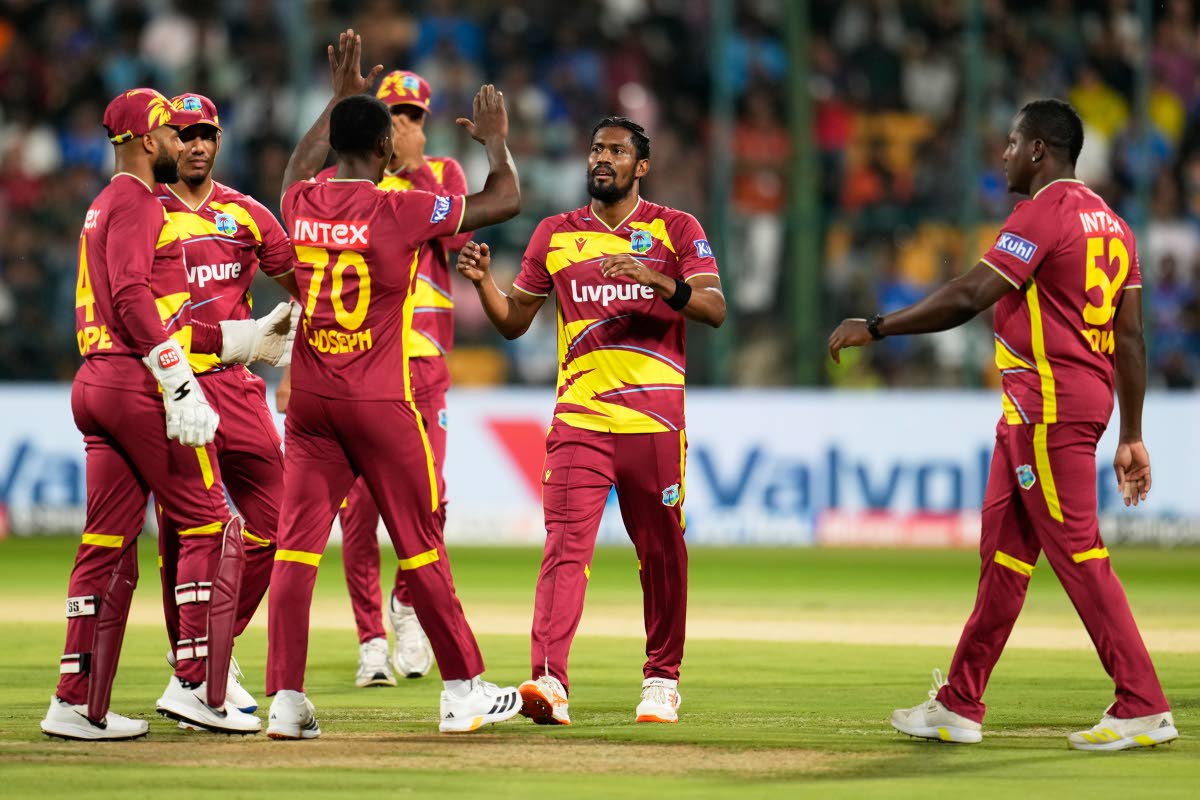 West Indies’ Keemo Paul (second right) celebrates with teammates the dismissal of India’s Abhishek Sharma during the fifth T20 International cricket match against India in Bengaluru, India.