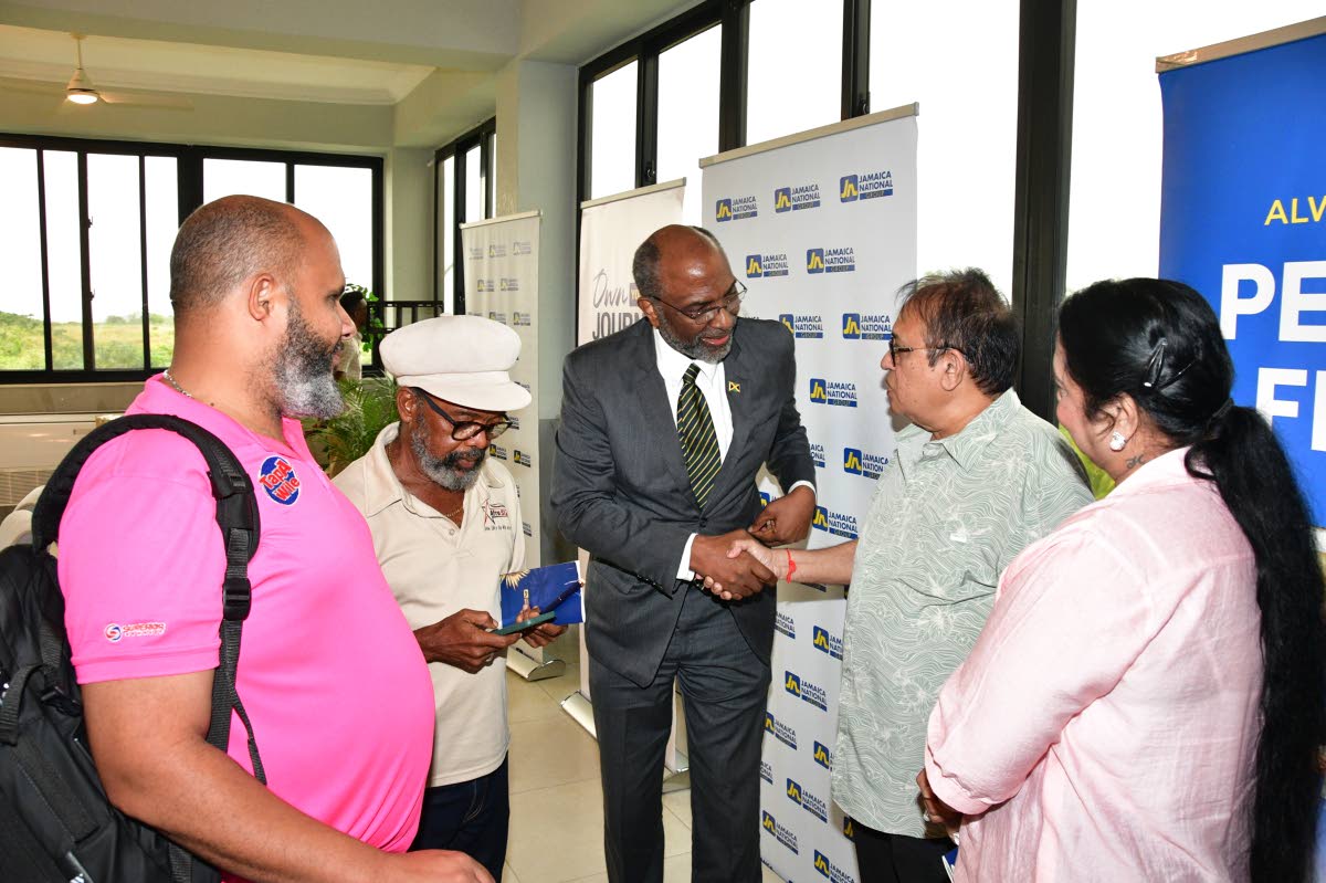Earl Jarrett (centre), chief executive officer (CEO) of the JN Group, greets Rajan Daswani (second right) and Hansa Daswani (right), owners of Divi Wholesale, during a business luncheon in St Ann, hosted by the JN Group on October 2. Also pictured are Chri