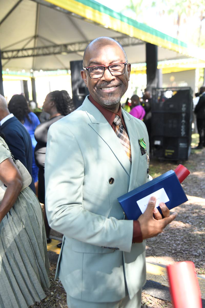 Evan Thompson, director of the Meteorological Service of Jamaica, poses for a photograph after being conferred with the Order of Distinction in the Rank of Officer during the National Honours and Awards Ceremony.