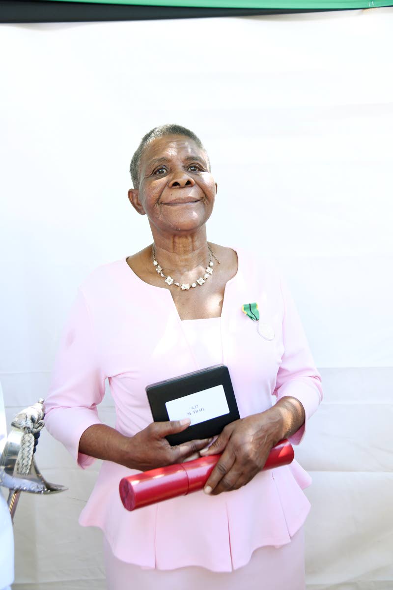 Retired midwife Myda Trail shows off her award on Monday for decades of service to midwifery.