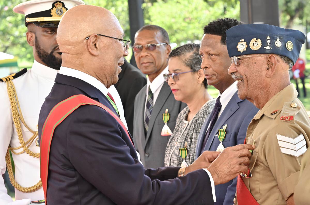 Sergeant (Ret’d) Peter Xavier ‘Poppy Man’ Williams receives the Order of Distinction in the Rank of Officer from Governor-General Sir Patrick Allen during the National Honours and Awards Ceremony 2026 at King’s House on Monday. Also present are fel