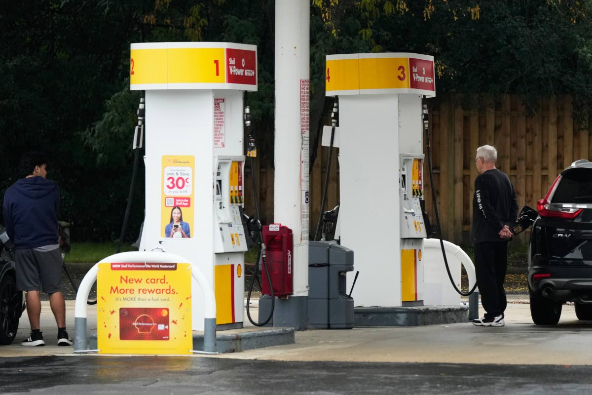 AP
Customers check the gas price while they fill up their vehicles in Arlington Heights, Illinois, on September 30. 
