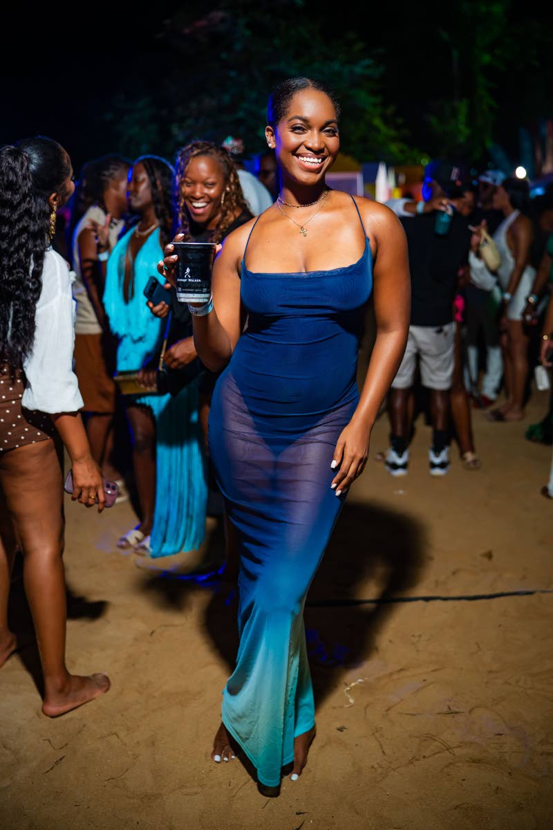 Sign Language Interpreter Mandy Cowan turns to shades of blue for her night out, choosing a mesh maxi dress and a Johnnie Walker cocktail.