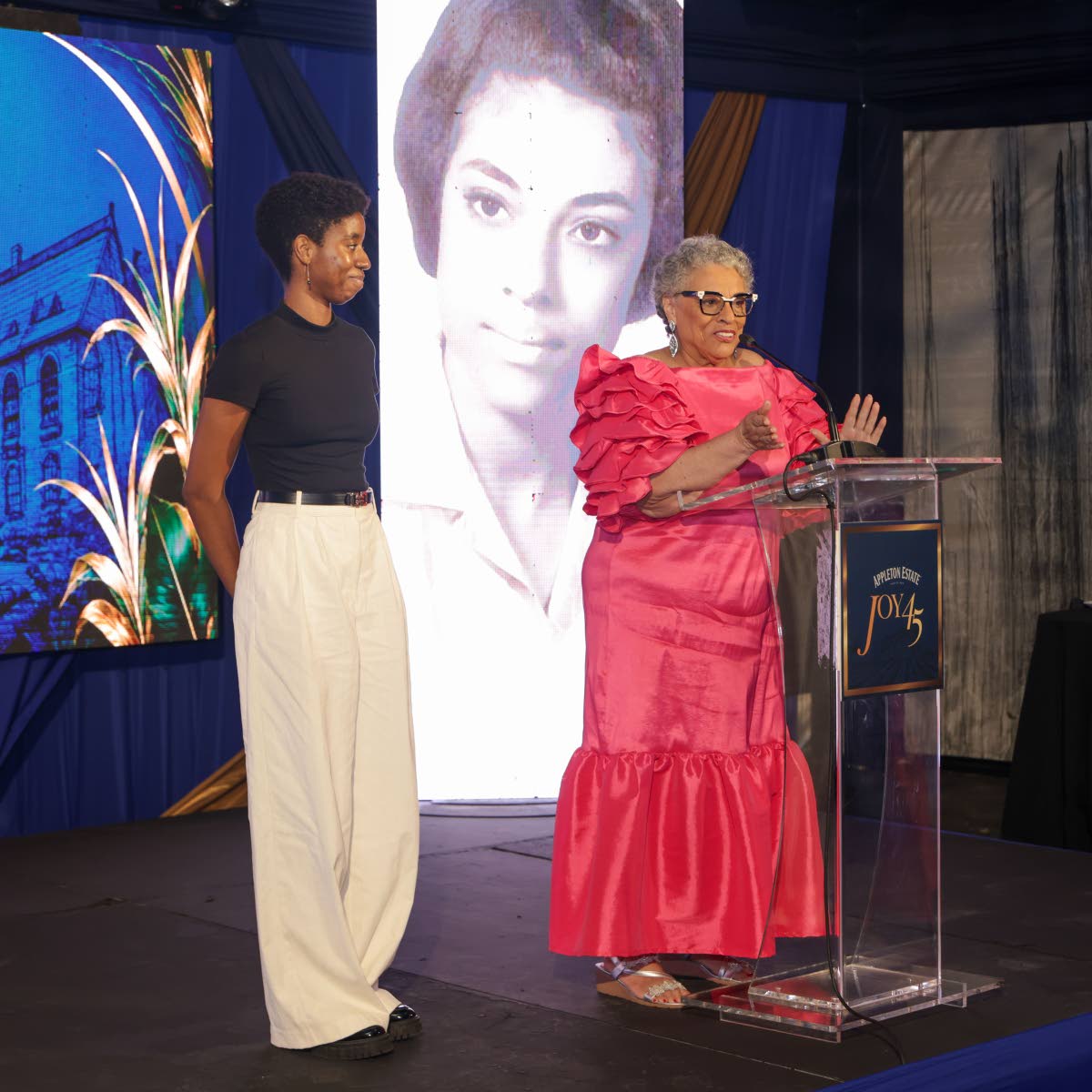 Cara Fraser (left) looks on as Appleton Estate Master Blender Dr Joy Spence speaks about the inspiration behind the Joy Spence Appleton Estate Scholarship in Chemistry and its role in creating opportunities for aspiring chemists during Joy45, a celebration