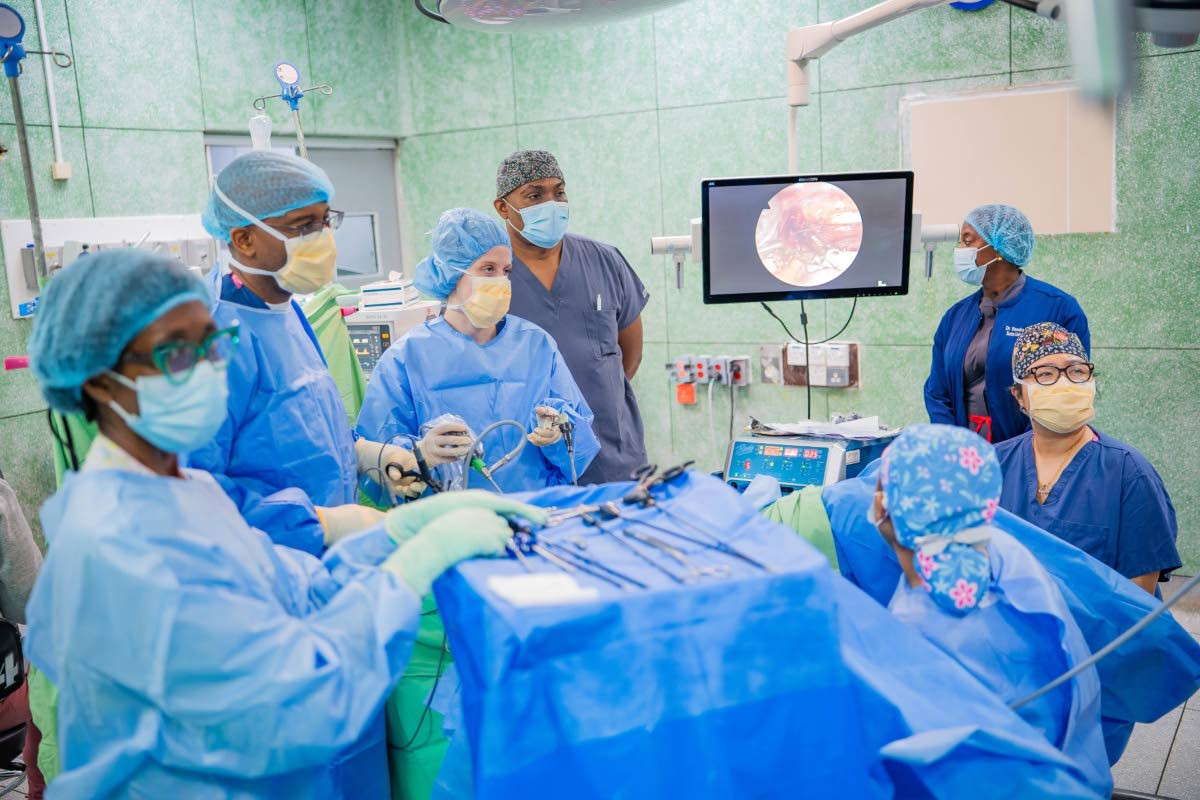 The joint surgical team including Northwell Health and the University Hospital of the West Indies (UHWI) performs a laparoscopic procedure in the operating theater at UHWI. 