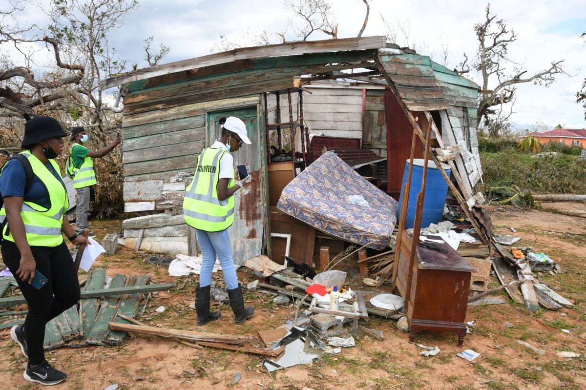 In this November 2, 2025 photo- five days after Hurricane Melissa- JN employee volunteers survey the rubble that was once the home of Vincent Wilson an elderly man, living alone, who was rescued by neighbours in Barton Wharf, Lacovia, St Elizabeth as the h