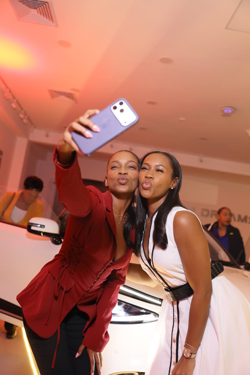 Daneilla McKenzie (left), media practitioner, and Toni-Ann Bedassie, content creator and entrepreneur, blow kisses for the camera.