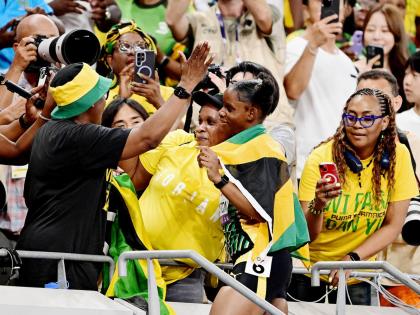 Tina Clayton (right, foreground) celebrates with her mom Tishawna Pinnock in the stands after winning the silver medal in the women’s 100 metre final on day two of the World Athletics Championships in Tokyo yesterday.