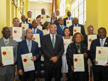 The Prime Minister and members of his cabinet pose for a photo: In front row (from left) are: Desmond McKenzie; Dr. Horace Chang; Prime Minister Dr. Andrew Holness; Olivia Grange; Robert Montague. Second Row: Daryl Vaz; Pearnel Charles Jr; Audrey Marks; Da