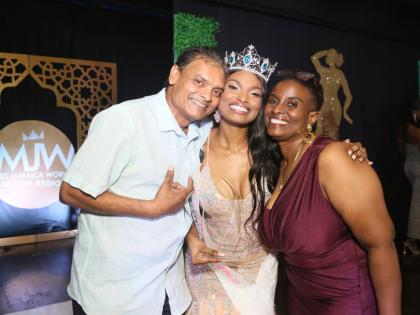 Proud parents Terry Roman (left) and Simone Ormsby hug their daughter, Kalea Roman (centre), the newly crowned Miss Jamaica World Eastern.