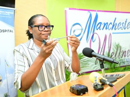 Urology Consultant at the Mandeville Regional Hospital, Dr Davon Mitchell, displays a urology instrument, during the handover of pieces of equipment, donated by the Manchester Wellness Foundation, at the hospital in Manchester on Friday. 