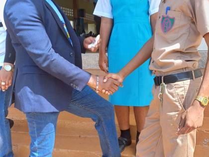 Chief Executive Officer of the Universal Service Fund (USF), Charlton McFarlane (left), greets grade 11 student at William Knibb Memorial High School in Trelawny, Amere Pugh (right), at the USF Influencer Creative Workshop held at the St Hilda’s High Sch