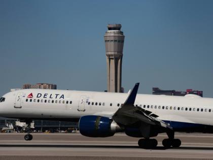 A plane lands at Harry Reid International Airport, Tuesday, October 7, 2025, in Las Vegas. (AP Photo/John Locher)