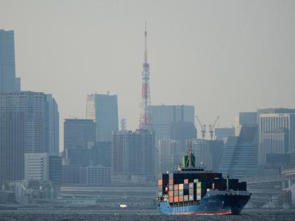 AP
Tokyo Tower is visible amid tall buildings as a container ship leaves a cargo terminal in Tokyo, April 2025. 