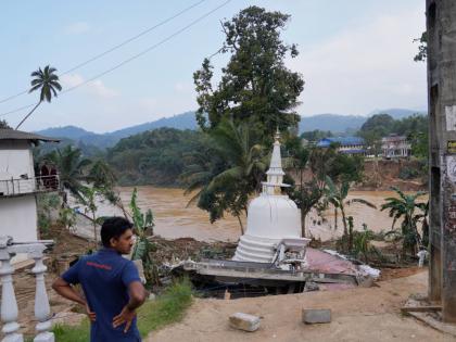 A man looks at the damage caused by the floods at Gampola, Sri Lanka.