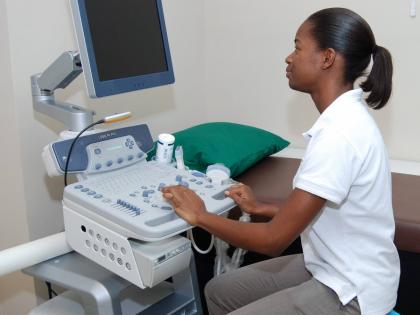 In this September 2013 photo, a technician operates a machine at Elite Diagnostics Limited in Kingston.