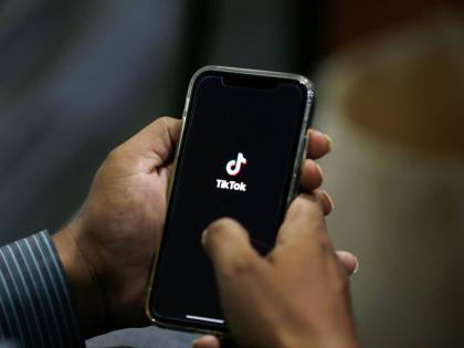  In this July 21, 2020 file photo, a man opens social media app TikTok on his cell phone, in Islamabad, Pakistan.