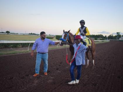 WE JAMMIN, with Omar Walker in the saddle, is flanked by trainer Peter-John Parsard (left) and groom Frank Spencer after capturing the Wayne DaCosta OD Two-year-old Stakes over a mile at Caymanas Park December 26, 2025.