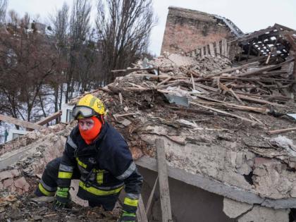 A rescue worker climbs onto the roof of an apartment building damaged after a Russian strike on Kyiv, Ukraine.