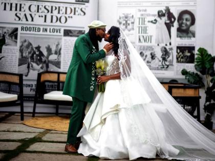 The couple share an enchanting kiss in front of an extravagant newspaper announcement marking their wedding.