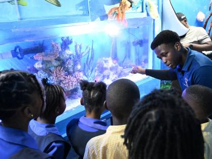 Outreach officer at the University of the West Indies (UWI) Discovery Bay Marine Laboratory in St Ann, Jason Grant, engages students of Waltham Abbey Primary and Infant School and Discovery Bay Primary and Infant School in an interactive showcase of the ne