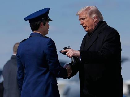 President Donald Trump greets Colonel Matha “Jeannie” Sasnett, commander of Air Force Mortuary Affairs, as he arrives on Air Force One at Dover Air Force Base, Delaware.
