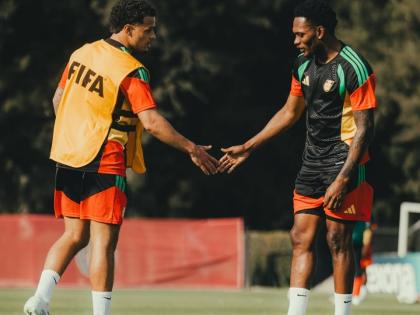 Reggae Boyz Bailey Cademarteri (left) and Renaldo Cephas greet each other during a training session in Mexico. 