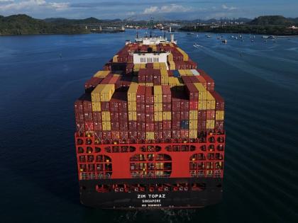 Cargo containers are stacked on a cargo ship moving through the Panama Canal, at sunrise in Panama City, Wednesday, March 25, 2026. (AP Photo/Matias Delacroix)