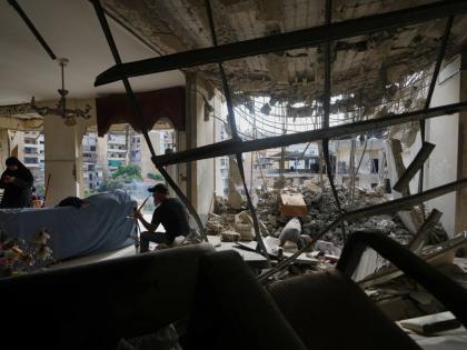 Fadi Al Zein, who lost both his homes in Israeli strikes in his village of Khiam and in Dahiyeh, smokes a water pipe inside his heavily damaged home in Beirut’s southern suburbs of Lebanon.