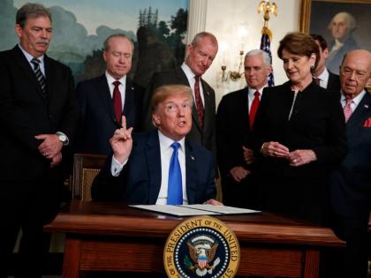 President Donald Trump speaks before he signs a presidential memorandum imposing tariffs and investment restrictions on China in the Diplomatic Reception Room of the White House, March 22, 2018, in Washington. (AP Photo/Evan Vucci, File)