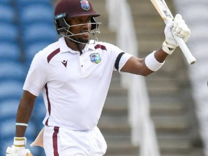 CWI Photo 
West Indies batsman Kavem Hodge raises his bat in celebration of a half-century on yestrday’s day one of a two-Test series against Pakistan at the Brian Lara Cricket Academy in Tarouba, Trinidad and Tobago yesterday.
