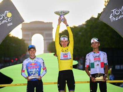 Slovenia’s Tadej Pogacar, wearing the overall leader’s yellow jersey, celebrates on the podium after winning the Tour de France cycling race alongside Belgium’s Remco Evenepoel, second, and Mexico’s Isaac Del Toro, third, in Paris, yesterday.